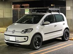 a small white car parked in a parking lot