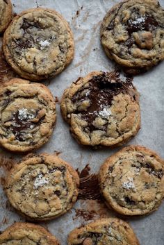 chocolate chip cookies are arranged on a baking sheet