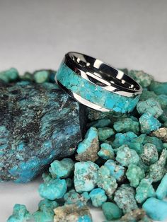 -Gorgeous Kingman Turquoise inlayed in a stainless steel band. -The Kingman Turquoise Mine is one of the oldest and highest producing Turquoise Mines in America. It was originally discovered by prehistoric Native Americans well over 1000 years ago. -All rings are unique and no two rings will be exactly the same. -Made with 100% Genuine Kingman Turquoise from Kingman, Arizona. -8mm wide band 4 mm wide inlay. -Handmade to order. -Unisex -(See last two photos for sizing). Polished Turquoise Ring As Gift, Polished Turquoise Ring For Gift, Turquoise Stainless Steel Jewelry As Gift, Turquoise Stainless Steel Jewelry Gift, Turquoise Stainless Steel Jewelry As A Gift, Kingman Arizona, 1000 Years, Sleeping Beauty Turquoise, Kingman Turquoise