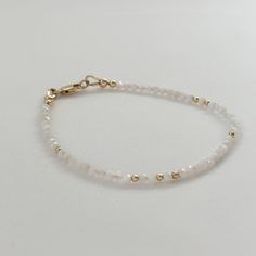 Unlock the magic of this Dainty Gemstone Moonstone Crystal Bracelet, a captivating piece of dainty gemstone beaded jewelry. With shimmering white moonstone that embodies the essence of the June birthstone, this bracelet makes a thoughtful and meaningful gift for birthdays and anniversaries. The healing properties of Moonstone bring a sense of peace and balance, making it an ideal companion for your daily journey. Wrap this delicate bracelet around your wrist and embrace the enchanting allure of Delicate White Adjustable Crystal Bracelet, Elegant Beaded Crystal Bracelet For Birthday, Dainty White Beaded Bracelet For Anniversary, Delicate White Crystal Bracelet Gift, Elegant White Bracelet With Birthstone, Spiritual Moonstone Rondelle Jewelry, Spiritual Round Beaded Bracelets For Anniversary, Elegant Moonstone Gemstone Beaded Bracelets, Delicate White Crystal Bracelet With Round Beads