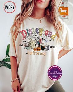 a woman wearing a disneyland california t - shirt with her hands on her hips and looking at the camera