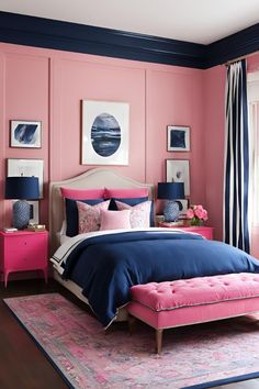 a bedroom with pink walls and blue bedding