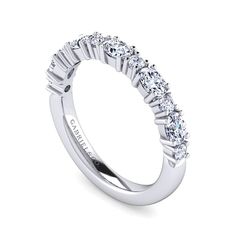 a white gold wedding band with five stones on the side and four rows of diamonds at the top