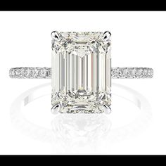 an emerald cut diamond ring with diamonds around it