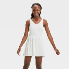 Why we're ALL IN: Solid-color sleeveless active dress with built-in shorts and a pleated skirt. Made from recycled polyester fabric with added spandex for flexible wear. Boasts moisture-wicking and quick-drying construction for comfort during any activity. The hidden pocket, built-in shorts, V-neckline and keyhole cut-out back complete the sporty design. All in Motion™: Inspiring the potential in every body. Summer V-neck Stretch Activewear, Stretch Mini Dress With Built-in Shorts, White Tennis Dress With Built-in Shorts For Summer, Stretch Sleeveless Dress With Built-in Shorts, Sleeveless Stretch Tennis Dress With Built-in Bra, Casual White Mini Dress With Built-in Bra, White Casual Mini Dress With Built-in Bra, Spring Tennis Dress With Built-in Shorts For Athletic Use, Spring Tennis Dress With Built-in Shorts For Workout