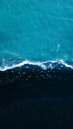 an aerial view of the ocean with waves