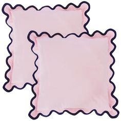 two pink scalloped pillows on white background