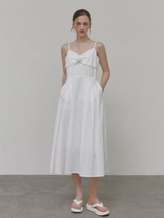 This product fuses elegance with simplicity, featuring a delicate corsage accent for a touch of romantic flair. The slender straps and sleek bodice cascade into a flowing skirt, creating a silhouette that's both timeless and modern. It's a versatile piece that can be dressed up for formal events or styled for a chic, casual look. - The dress boasts a flattering slip design, accentuated by a tasteful corsage detail for an added element of sophistication.- Its fluid skirt and fitted waist highlight the body's contours while providing comfort and ease of movement.- The fine straps and squared neckline present a display of minimalistic charm, suitable for various occasions.- Crafted with a blend of grace and practicality, this dress stands out with its understated beauty and functional el Elegant Midi Dress With Sweetheart Neckline And Delicate Straps, Elegant Suspender Dress With Adjustable Straps And Fitted Bodice, Elegant Suspender Dress With Adjustable Straps For Formal Occasions, Elegant Evening Suspender Dress With Delicate Straps, Elegant Formal Suspender Dress With Adjustable Straps, Elegant Dress With Sweetheart Neckline And Adjustable Straps, Elegant White A-line Suspender Dress, White A-line Elegant Slip Dress, Elegant Suspender Dress With Adjustable Straps