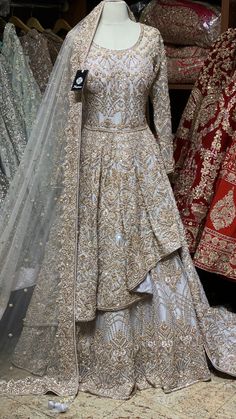 a mannequin is dressed up in a wedding gown and veil for sale at a store