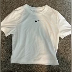 This White Nike Tee Is A Perfect Lightweight Cotton Material! It Has A Black Nike Check In The Middle, Is Slim Fitting, And Slightly Cropped. Never Worn! Nikey Mucle Shirts, White Crop Top Nike, Cheap Calvin Klein Short Sleeve T-shirt, Basic Nike Crew Neck Top, Nike Basic Tops For Spring, Nike Basic Summer Tops, Basic White Nike Top, Air Port, Tee Shirt Outfit