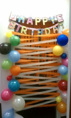 a birthday decoration with balloons and streamers