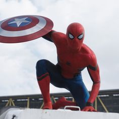 a statue of spider - man is in the air with a frisbee