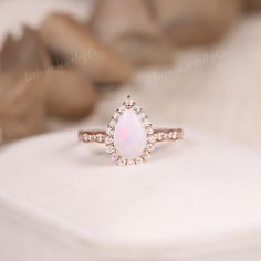 Unique Opal Wedding Ring Women Rose Gold Pear Cut Fire Opal Engagement Ring Dainty Halo Ring Moissanite White Gemstone Ring Anniversary Gift ✦ Handmade, high-quality item ✦ Material: SOLID 14K/18K GOLD ( can be made in yellow/white/rose gold ) ✦Engagement ring ✦ Center stone: Lab Opal ✦ Size/Weight: 6*9mm ✦ Color: White with Fire ✦ Cut: Pear Shaped ✦ Side stones: Moissanite ✦ Weight: About 0.396ct ✦ Color: DEF Color ✦ Cut: Round Shaped ✦ Band Width: Around 1.5mm PRODUCTION We are jewelry artisan Oval Pink Opal Ring For Wedding, White Teardrop Opal Ring For Anniversary, Opal Halo Wedding Jewelry, White Pear-shaped Opal Ring For Gift, White Opal Ring, Pear-shaped For Wedding, Opal Rings With Halo Setting For Weddings, Wedding Opal Ring Pear-shaped, Pear-shaped White Opal Ring For Anniversary, White Pear-shaped Opal Ring For Wedding