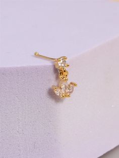 Introducing our charming variety of dangling nose studs, crafted to add a touch of romance to your look. Made from high-quality copper and adorned with sparkling cubic zirconia, this piece is the perfect blend of cute and romantic style. Its heart-shaped design adds an enchanting allure, making it a standout accessory for any occasion. Whether you're aiming for a cute everyday look or a romantic evening ensemble, this nose ring/stud is sure to capture hearts. Elevate your style and showcase your unique personality with these today! Dainty Cubic Zirconia Wedding Piercings, Gold Cubic Zirconia Wedding Piercings, Elegant Rose Gold Piercings With Cubic Zirconia, Elegant Rose Gold Cubic Zirconia Piercings, Dainty Cubic Zirconia Drop Earrings Piercings, Cubic Zirconia Drop Earrings Piercing, Cubic Zirconia Dangle Piercings For Gift, Cubic Zirconia Dangle Piercings As Gift, Elegant Piercings With Sparkling Stones For Gift