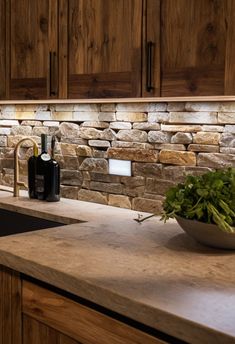 a kitchen counter with a bowl of greens on top of it next to a sink