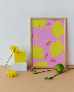 a yellow flower sitting on top of a table next to a green vase