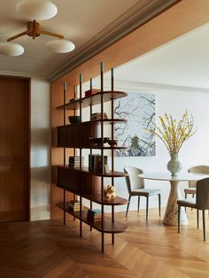 a dining room with wooden floors and shelves