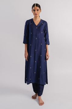 Navy blue spun silk kurta with sequins placement hand embroidery. Comes with pant.
Components: 2
Pattern: Hand embroidered
Type Of Work: Sequins
Neckline: V Neck
Sleeve Type: Three quarter
Fabric: Spun silk
Color: Blue
Other Details: 
Side slits
Occasion: Puja - Aza Fashions Embroidered Cotton Silk Palazzo Set For Eid, Festive Pant Set With Mirror Work And Straight Kurta, Festive Straight Kurta Pant Set With Mirror Work, Embroidered Straight Kurta Sets In Slub Silk, Embroidered Slub Silk Straight Kurta Set, Embroidered Slub Silk Sets With Straight Kurta, Embroidered Cotton Silk Palazzo Set With Straight Kurta, Designer Mirror Work Straight Kurta Pant Set, Designer Straight Kurta Pant Set With Mirror Work