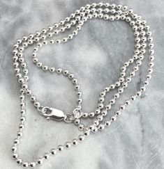 "Solid 925 Sterling Silver Chain Design: Ball Chain Also available in Box, and Cable& Figaro Design. Versatile, high-quality chain made of genuine sterling silver with 925 stamp and spring ring lock. It is hypoallergenic (nickel and toxic-chemical free) thus not prone to any allergies. Available in:  16 inches 18 inches 20inches If you want in any other size& design, i can make it for you. USE: It makes the perfect gift, too. - Add your own pendants. - Great for wearing on their own. - Wear them layered with other necklace Ball chain measures 1.25mm beads, and all chains includes most commonly length i.e. 16\", 18\" and 20\". For specific design or measurement, feel free to reach out, AFTER CARE: It is given in a Ziploc bags. These are the best and very affordable way to keep your sterling Silver Jewelry With Box Chain And Round Beads, Classic Ball Chain Necklace As Gift, Silver Necklace With Box Chain And Round Beads, Silver Ball Chain Necklace As A Gift, Classic Sterling Silver Necklace With Ball Chain, Silver Necklace With Ball Chain As Gift, Silver Necklace With Ball Chain For Gift, Silver Round Beads Chain Necklace Gift, Silver Jewelry With Ball Chain For Gift