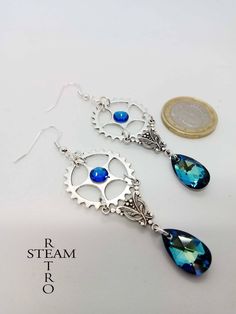 Silver plated filigree earrings with 925 sterling silver hooks and Swarovski Bermuda blue gemstones. These stunning Steampunk earrings will be gift boxed FREE of charge! We offer FREE shipping on the second any any subsequent items when you shop with us All you need to do is add the item to your Shopping Cart and pay with Etsy's checkout system and we will dispatch your parcel via Certified US Postal Service (in most cases it will ship within 24 hours of payment), Monday through Friday. Part of Gear Earrings, Fashion Reference, Accessories Ear, Victorian Earrings, Steampunk Earrings, Steampunk Victorian, Steam Punk Jewelry, Punk Earrings, March Birthstone Jewelry