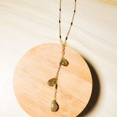 Enhance your neckline with our Gem Tassel Necklace, featuring delicately detailed Y design adorned with three stunning gemstones. Available in labradorite or strawberry quartz, this necklace is a subtle yet sexy addition to any outfit. ⬩8mm Pear shape⬩16-inch Gold Plated necklace w/ 2-inch Y Drop⬩2-inch extender at back⬩Available in Labradorite (Gray/Blue) or Strawberry Quartz (Rose Pink) This item is HandmadeThis item will ship with gemstone information on the Santore Jewelry Card included with Gold Necklaces With Natural Labradorite Stones, Gold Labradorite Necklaces With Natural Stones, Elegant Gold Necklace With Labradorite, Labradorite Drop Gemstone Necklaces, Elegant Labradorite Necklace With Adjustable Chain, Gold Bohemian Briolette Crystal Necklace, Adjustable Labradorite Necklace, Gold Labradorite Necklace With Gemstone Beads, Gold Labradorite Gemstone Necklace