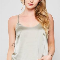 A Solid Satin Camisole Top Featuring Scoop Neckline, Adjustable Shoulder Straps, Sleeveless, And Side Slits. Model Info: Height: 5 Ft 10 In | Bust: 32 In | Waist: 24 In | Hips: 35 In | Wearing Size S. Sleeveless Tank Top With Delicate Straps For Night Out, Delicate Straps Tank Top For Night Out, Cami Tank Top With Delicate Straps For Night Out, Night Out Tank Top With Delicate Straps, Chic Cami Tank Top With Adjustable Straps, Night Out Cami Tank Top With Delicate Straps, Chic Solid Tank Top With Delicate Straps, Chic Solid Color Tank Top With Delicate Straps, Chic Solid Color Camisole