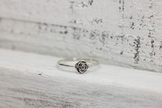 Someone once said that flowers are God's sweetest creations without a soul, and we couldn't agree more and the rose is the most beloved flower of all time. Roses symbolize love and happiness. This dainty rose ring is the perfect way to express your love, friendship or admiration for your beloved! Crafted from sold sterling silver. This ring is beautiful on its own or looks lovely stacked with my sterling silver vine ring linked below. ✥ Sterling Silver ✥ Available in sizes 3-10 ✥ Beautifully box Dainty Rose Design Flower Ring For Gift, Dainty Rose Design Flower Ring Gift, Dainty Rose Design Flower Ring For Anniversary, Dainty Rose Design Flower Promise Ring, Rose Design Rings For Valentine's Day, Flower Shaped Rings With Roses For Gift, Dainty Rose Colored Rings As Gift, Delicate Rose Colored Rings For Gift, Adjustable Rose Design Flower Ring For Anniversary