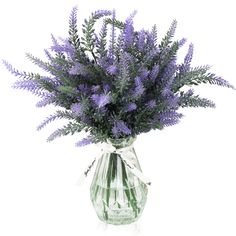 a vase filled with purple flowers on top of a white table