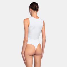 The TANKTOP Bodysuit is the perfect basic, crafted from an ultra-soft fabric blend that hugs your body flawlessly. Designed for both comfort and style, this bodysuit provides a sleek, form-fitting silhouette, making it an essential piece for any wardrobe.Size and fit:• The bodysuit runs small; we suggest sizing up• White can be slightly see-throughInfo:• 48% cotton, 48% modal, 4% spandex• Gusset hook and eye closure with thong back• Machine wash (mild detergent, iron, no bleaching, dry flat, do Back Machine, Soft Fabric, Best Sellers, Sleek, Spandex, Tank Tops, Wardrobe, Fabric, White