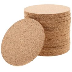 several cork coasters stacked on top of each other in front of a white background