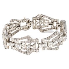 Art Deco platinum and diamond bracelet, designed as a series of openwork geometric links set throughout with various-cut diamonds weighing approximately 9.00 carats, GH color VS clarity. The gross weight is 37.2 grams, length 7 ⅛ inches, width ¾ inch. Period Jewelry, Platinum Bracelet, Deco Jewelry, Art Deco Diamond, Art Deco Jewelry, Diamond Bracelets, A Series, Vintage Brooches, White Diamond