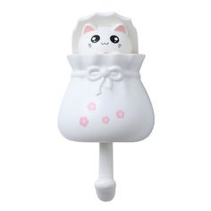 a white cat shaped toothbrush holder with pink flowers on it's head and eyes