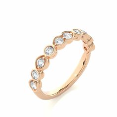 a rose gold ring with five diamonds on the top and bottom, set in 18k yellow gold