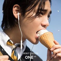 a man eating an ice cream cone with headphones on his ears and earbuds