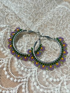 Hand beaded hoop earrings.  Hinge closure. Hoop measures approximately 1" wide. Beaded Hoop Festival Jewelry, Beaded Hoop Jewelry For Festivals, Beaded Small Hoop Earrings In Metal, Small Hoop Beaded Metal Earrings, Nickel Free Small Hoop Beaded Earrings In Trendy Style, Beaded Metal Small Hoop Earrings, Beaded Metal Hoop Earrings, Small Beaded Metal Hoop Earrings, Small Beaded Hoop Earrings In Metal