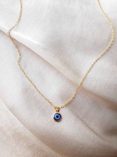 24K gold plated handmade necklace with a small blue evil eye pendant (For the baby blue evil eye necklace in the picture, check out this listing: https://www.etsy.com/uk/listing/1043552572/24k-gold-plated-small-baby-blue-evil-eye?ref=shop_home_active_2&frs=1) Chain length:17 inches (~42.5cm) Chain length may be shortened FREE of charge, please add the length you would like in the personalisation box below upon ordering or message me! Everything comes beautifully wrapped, with a small jewellery p Everyday Blue Tarnish-resistant Jewelry, Minimalist Handmade Gold Charm Necklace, Blue Charm Necklaces With Round Pendant For Everyday, Blue Pendant Charm Necklaces For Everyday, Blue Pendant Charm Necklace For Everyday, Blue Charm Necklace With Adjustable Chain For Everyday, Blue Round Charm Necklaces For Everyday, Everyday Blue Pendant Charm Necklaces, Dainty Tiny Charm Necklaces Gold Plated