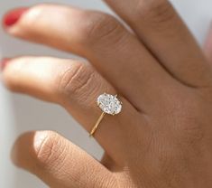 a woman's hand with a diamond ring on it