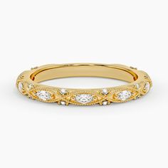 a yellow gold wedding band with diamonds