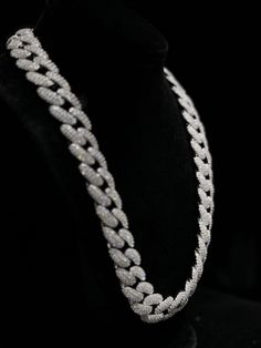 Miami Cuban Link Chain (18mm) Elevate your style with this bold and striking 18mm Cuban link chain, expertly crafted from high-quality stainless steel and adorned with dazzling cubic zirconia stones. Designed for those who appreciate luxury and durability, this chain combines classic elegance with a modern edge, making it the perfect statement piece for any occasion. Key Features: Material: Premium stainless steel, ensuring durability and resistance to tarnish and rust. Stones: High-grade cubic zirconia stones meticulously set into each link for a brilliant shine that rivals real diamonds. Width: 18mm Clasp: Secure fold-over clasp for easy wear and a reliable fit. Length Options: Available in various lengths to suit your style preference. Versatile Style: Perfect for layering or wearing so White Cuban Link Necklace In Cubic Zirconia, White Cuban Link Necklace With Cubic Zirconia, Silver Cuban Link Necklace Iced Out With Cubic Zirconia, Silver Cuban Link Necklace With Iced Out Cubic Zirconia, Iced Out Cubic Zirconia Link Chain Necklace, Iced Out Link Chain Necklace With Cubic Zirconia, Luxury Iced Out Link Chain Necklace, Silver Cubic Zirconia Iced Out Chain Necklace, Iced Out Cubic Zirconia Chain Necklace