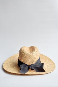 Straw panama hat with a black grosgrain tie. Made of natural straw, The Everywhere Hat has a wide brim that protects you from the sun while looking casual and modern. The adjustable grosgrain ribbon can be custom tied for a perfect fit to your head size, plus it adds the perfectly sweet accent to pair with breezy outfits for a stylish sunny look. Content:- Raffia Straw- Imported Size:- One Size Fits All, Adjustable- Crown: 5.5"- Brim: 4" AVAILABLE FOR PRESALEEstimated to Ship 2/17/2021 Breezy Outfit, Straw Panama Hat, Custom Ties, Black Ribbon, Wide Brimmed, Straw Hat, Grosgrain Ribbon, Your Head, Summer Looks