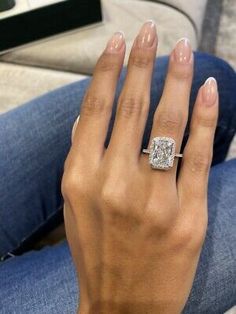 a woman's hand with a diamond ring on it