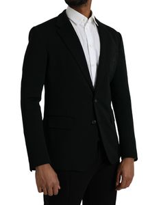 This single breasted blazer from Dolce & Gabbana features a two button closure, notched lapels, and a slim fit. Crafted from a luxurious black wool-silk blend, the blazer is detailed with an embroidered logo on the front chest patch pocket and two side flap pockets. The long sleeves, curved hem, and one open vent in the back add a sleek touch to the blazer's design. Made in Italy, the lining is made of 92% silk and 8% elastane, while the material is composed of 92% virgin wool and 8% nylon.