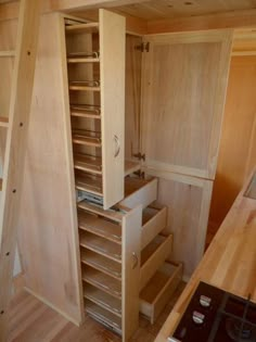 a kitchen with wooden cabinets and drawers in it