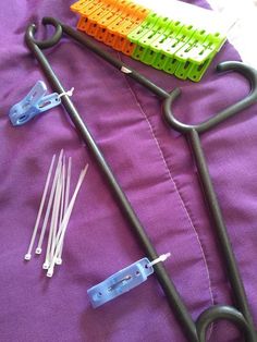 several medical instruments are laying on a purple sheet with white and blue pins attached to them