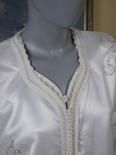 This Middle Eastern khaleeji robe two-piece consists of a sheer nylon mesh overdress with gold, white, and silver embroidery and sequins and an opaque ivory white satin underdress. The stunning slip-on gown (both the overdress and underdress) has a Queen Anne neckline edged with an embroidered gold band and long wide angel sleeves. Underdress measurements: Bust = 45 inches (114.3cm) Shoulders = 18 inches (45.72cm) Waist = 45 inches (114.3cm) Hips = 48 inches (121.92cm) Sleeve Length = 24.5 inche Arab Princess, Royal Blue Coat, Norwegian Wool Sweater, Queen Anne Neckline, Silver Embroidery, Angel Sleeves, 1960s Fashion, European Vintage, Plaid Blazer