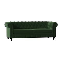 a green couch sitting on top of a white floor