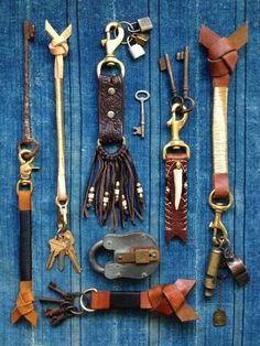 several different types of keys and other items laid out on a blue surface with wood planks