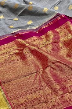 This stunning kanjivaram saree in english grey is handwoven. The bavanji borders have geometrical patterns in magenta pink in gold zari! This exquisite saree is adorned with chakram and peacock motifs in gold zari while the grand pallu with traditional annam motifs in gold zari. Truly a masterpiece! Approximate Length 6.25 - 6.50 mtrs (inclusive of blouse length) Approximate Height - 46 - 52” Saree comes with fall, picot and tassels done when applicable . Blouse piece is cut. Approximate weight Peacock Motifs, Kanjivaram Saree, Kanjivaram Silk Saree, Silk Cotton Sarees, Kanjivaram Sarees, Magenta Pink, Cotton Sarees, Blouse Length, Support Team