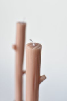 two tall candles sitting next to each other