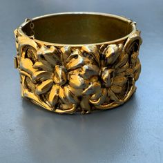 Gorgeous ~ Wide ~ Victorian Revival ~ gold tone ~ hinged bangle ~ With raised /repousse floral pattern ~ Hidden tongue and box clasp with double safety chain . Signed LISNER on inner side of bangle . Dates : mid to late 20th century Measurements : Bracelet Measures 7 1/4 inches in inner length x 1 1/2 inches max width . Condition : Overall good vintage condition with minor age related wear ~ Clasp is in good working order ~ Gold gilding shows some wear /loss . Please Note ~ As Antique /vintage i 1920s Necklace, Victorian Revival, Vintage Bangles, Victorian Gold, Safety Chain, Box Clasp, Vintage Victorian, Gold Gilding, Hinged Bangle